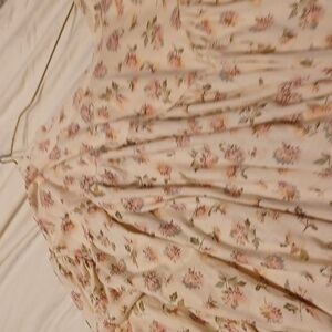 Cream color long sleeve shirt with flower patterns.